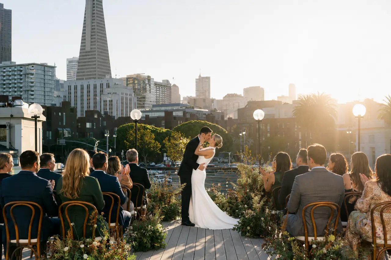 The Historic Klamath bride groom kiss at ceremony with san francisco skyline